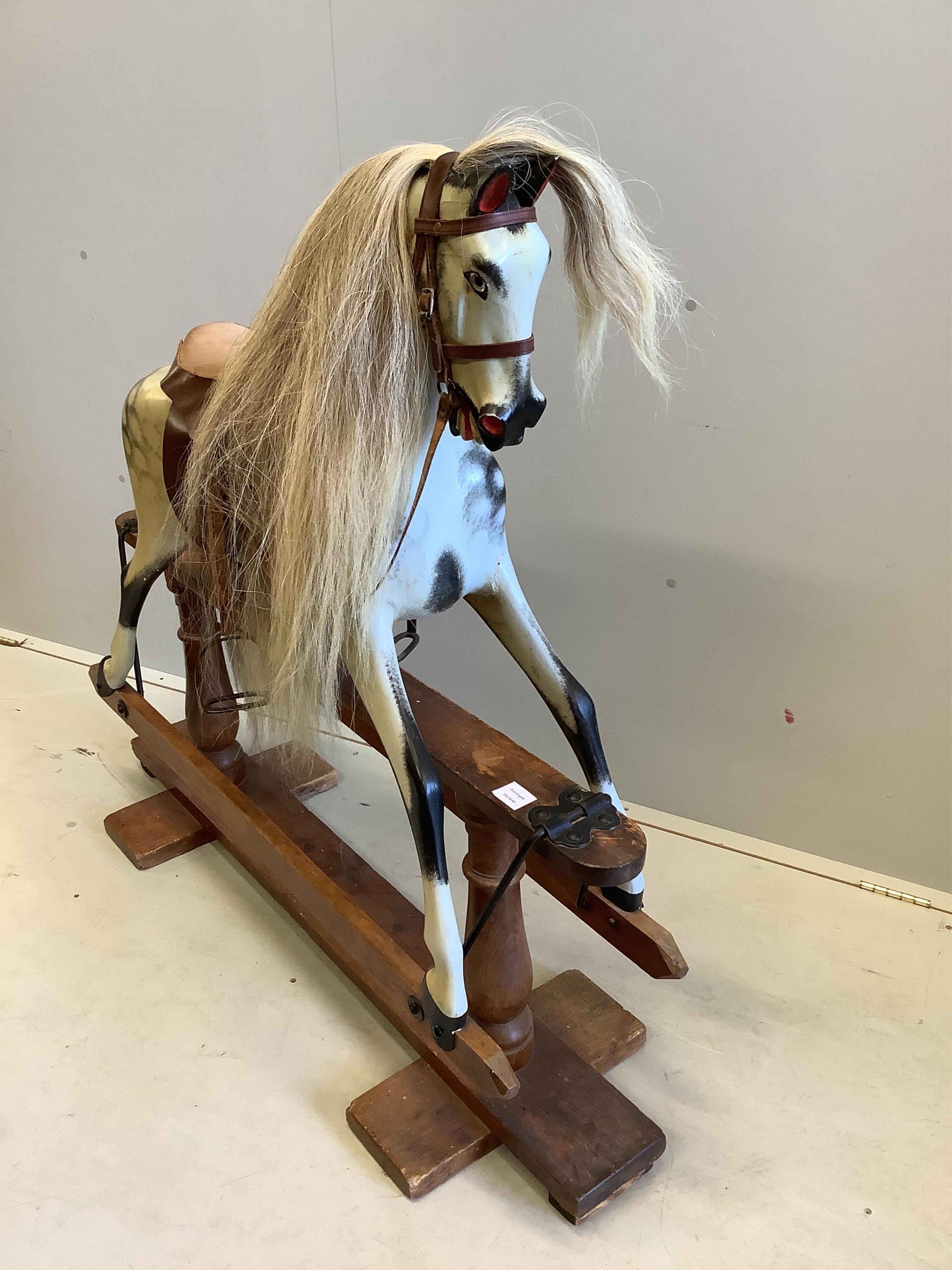 An early 20th century dapple grey rocking horse on pine safety frame, width 126cm, height 116cm. Condition - fair-good